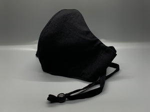 Handmade Triple Layer Cotton Facemask. Solid black cotton. Black filter pocket. Overhead/Back of Head cotton loop from same fabric. Adjustable Wood Bead for perfect fit. This mask has no nose wire-the adjustable overhead loop gives you a snug fit. Cut from one cloth-meaning fabric is same and where your pattern lies may vary. non-returnable/non-refundable. non medical grade. not a replacement for medical grade personal protective equipment (PPE), surgical masks, N95s, or social distancing. Follow all recomm