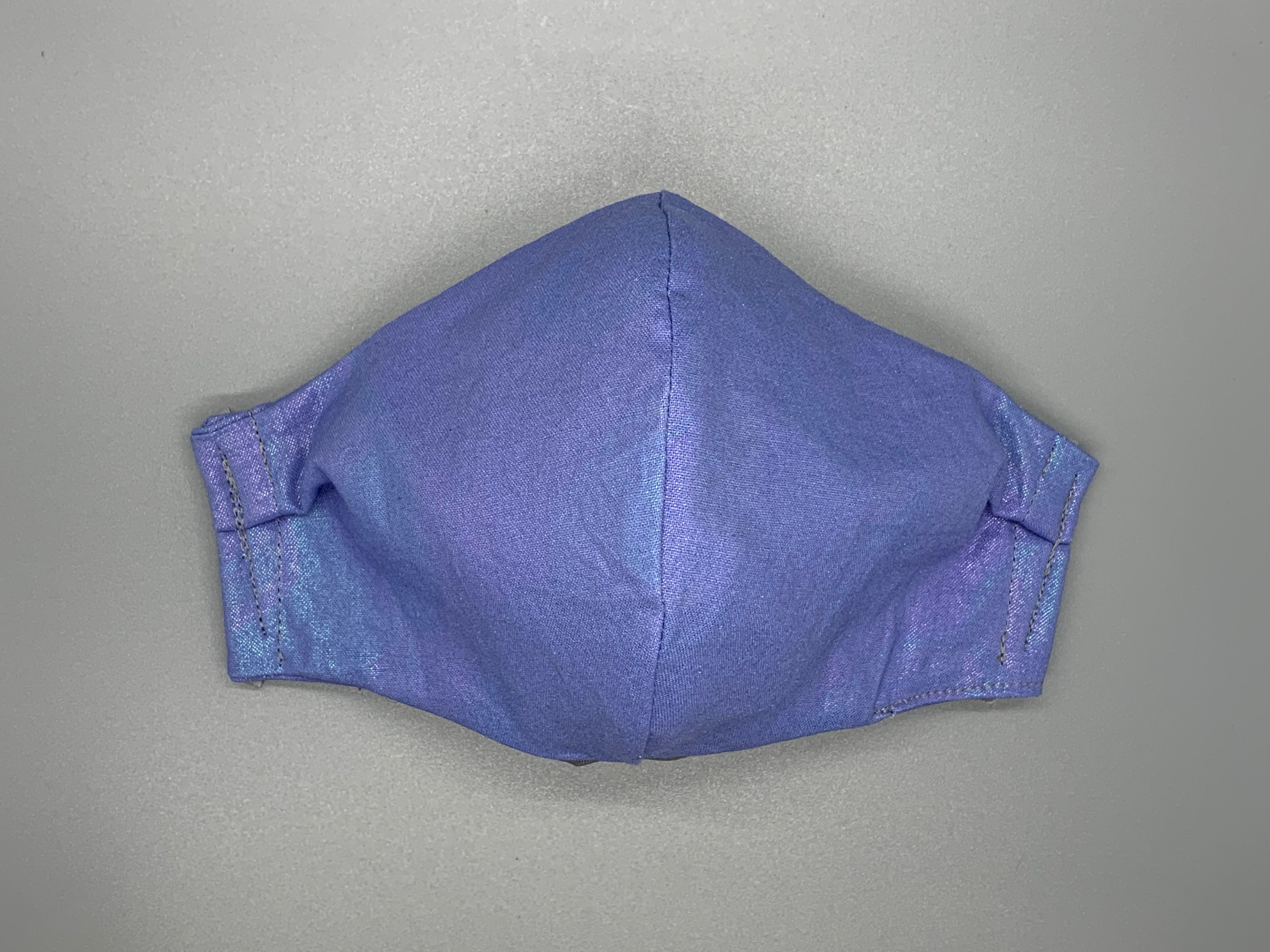 Dreamy Irridescent purple ombre cotton. Fabric enclosed nose wire. Gray filter pocket. Comfy adjustable gray earloops.  Cut from one cloth-meaning fabric is same and where your pattern lies may vary. non-returnable/non-refundable. non medical grade. not a replacement for medical grade personal protective equipment (PPE), surgical masks, N95s, or social distancing. follow all recommended CDC guidelines.