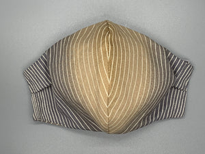 Handmade Triple Layer Cotton Facemask. Tan and brown ombre beneath thin white stripes. Gray filter pocket. Fabric enclosed nose wire. Comfy adjustable gray earloops. Cut from one cloth-meaning fabric is same and where your pattern lies may vary. non-returnable/non-refundable. non medical grade. not a replacement for medical grade personal protective equipment (PPE), surgical masks, N95s, or social distancing. follow all recommended CDC guidelines.