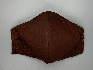 Handmade Triple Layer Cotton Facemask. Melanin brown cotton covered in gold flecks. Gray filter pocket. Comfy adjustable gray earloops. Cut from one cloth-meaning fabric is same and where your pattern lies may vary. non-returnable/non-refundable. non medical grade. not a replacement for medical grade personal protective equipment (PPE), surgical masks, N95s, or social distancing. follow all recommended CDC guidelines.