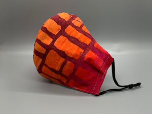 Takes me back to Hawaii's fiery sunsets. Hues of purple and orange with rectangle shapes throughout. Gray filter pocket. Fabric enclosed nose wire. Comfy adjustable black earloops.  Cut from one cloth-meaning fabric is same and where your pattern lies may vary. non-returnable/non-refundable. non medical grade. not a replacement for medical grade personal protective equipment (PPE), surgical masks, N95s, or social distancing. follow all recommended CDC guidelines.