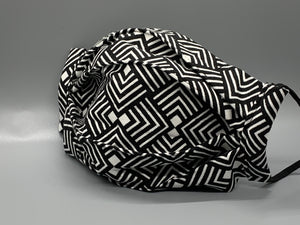 Black and white lined pattern repeats on this bold fabric. Fabric enclosed nose wire. Comfy adjustable black elastic earloops. This mask has no filter pocket. It still has 3 layers of cotton plus one layer non woven interfacing. 