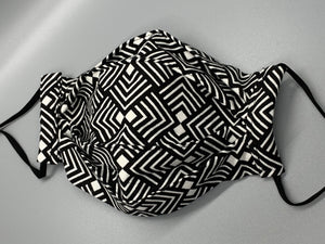 Black and white lined pattern repeats on this bold fabric. Fabric enclosed nose wire. Comfy adjustable black elastic earloops. This mask has no filter pocket. It still has 3 layers of cotton plus one layer non woven interfacing. 