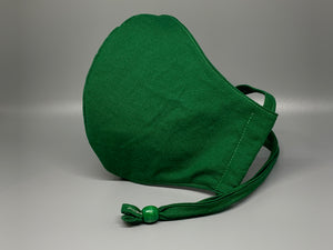 Vibrant solid green cotton. Gray filter pocket. Overhead/Back of Head cotton loop from same fabric. Adjustable Wood Bead for perfect fit. This mask has no nose wire-the adjustable overhead loop gives you a snug fit.