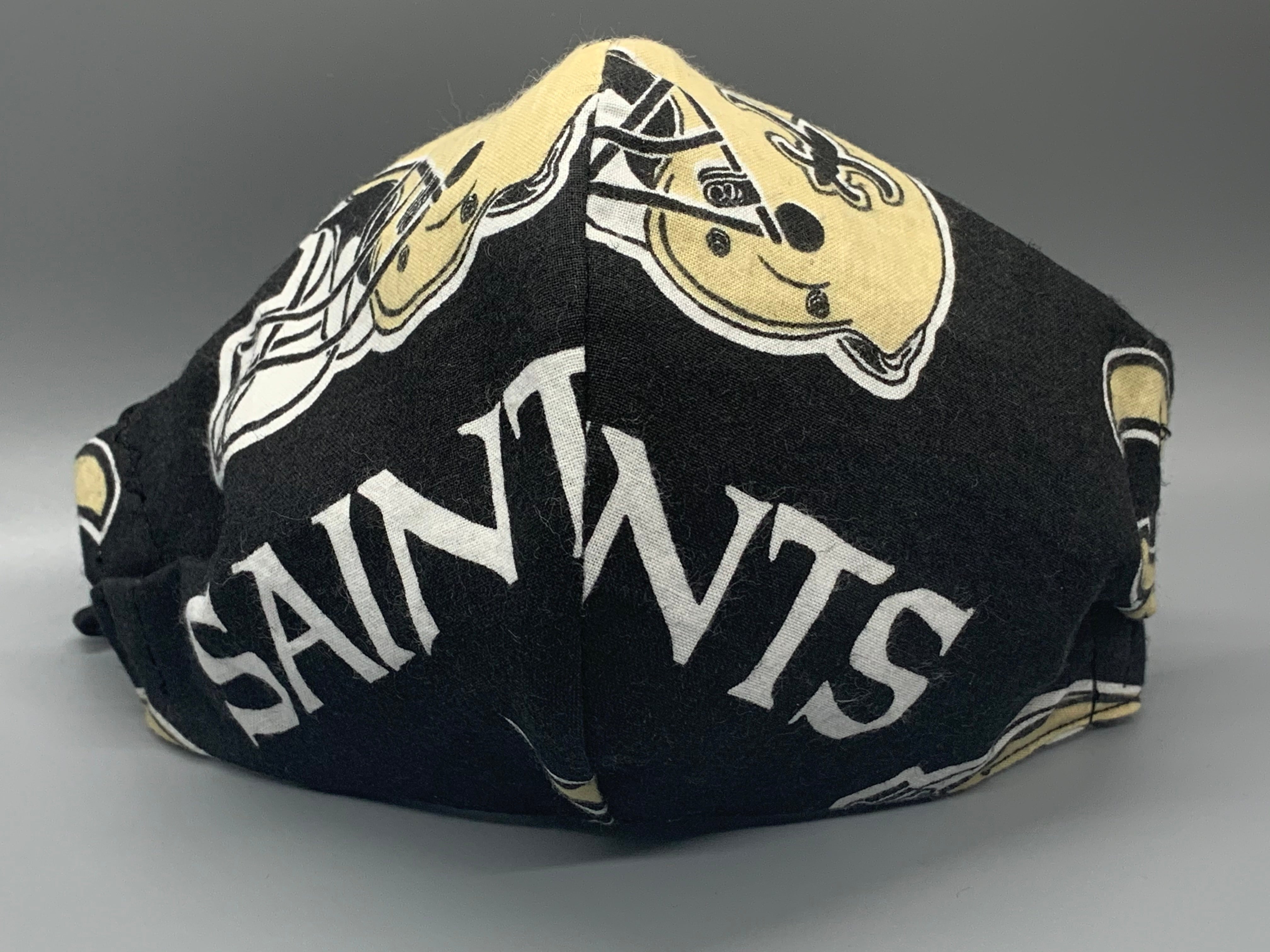 Handmade triple layer cotton facemask. Saints Fans, get your gear! Fabric enclosed nose wire. Black filter pocket. Comfy adjustable black elastic ear loops.