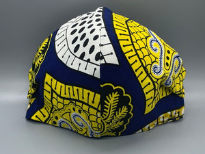 Handmade triple layer cotton facemask. Gorgeous blue, fabric with symbols/pattern in yellow white and black. The ream stated this fabric is from Ghana (or inspired by their amazing prints). Fabric enclosed nose wire. Grey filter pocket. Comfy adjustable black elastic ear loops.