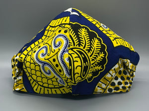 Handmade triple layer cotton facemask. Gorgeous blue, fabric with symbols/pattern in yellow white and black. The ream stated this fabric is from Ghana (or inspired by their amazing prints). Fabric enclosed nose wire. Grey filter pocket. Comfy adjustable black elastic ear loops.