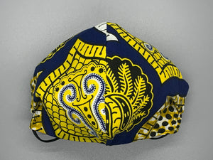 Handmade triple layer cotton facemask. Gorgeous blue, fabric with symbols/pattern in yellow white and black. The ream stated this fabric is from Ghana (or inspired by their amazing prints). Fabric enclosed nose wire. Grey filter pocket. Comfy adjustable black elastic ear loops.